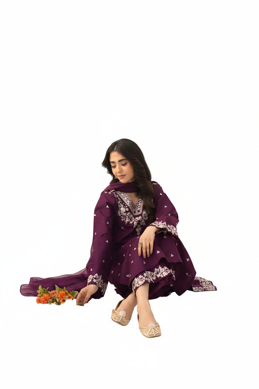 Woman wearing a purple traditional outfit with floral patterns on a white background